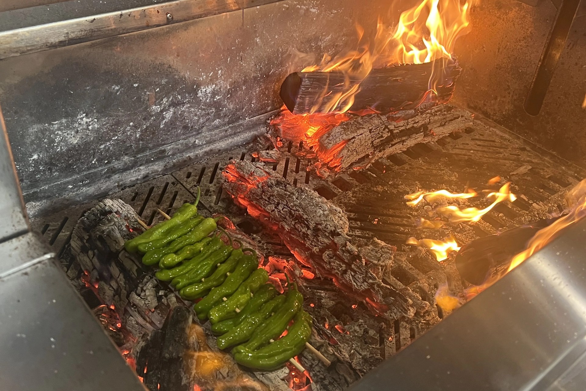 peppers cooking on coals