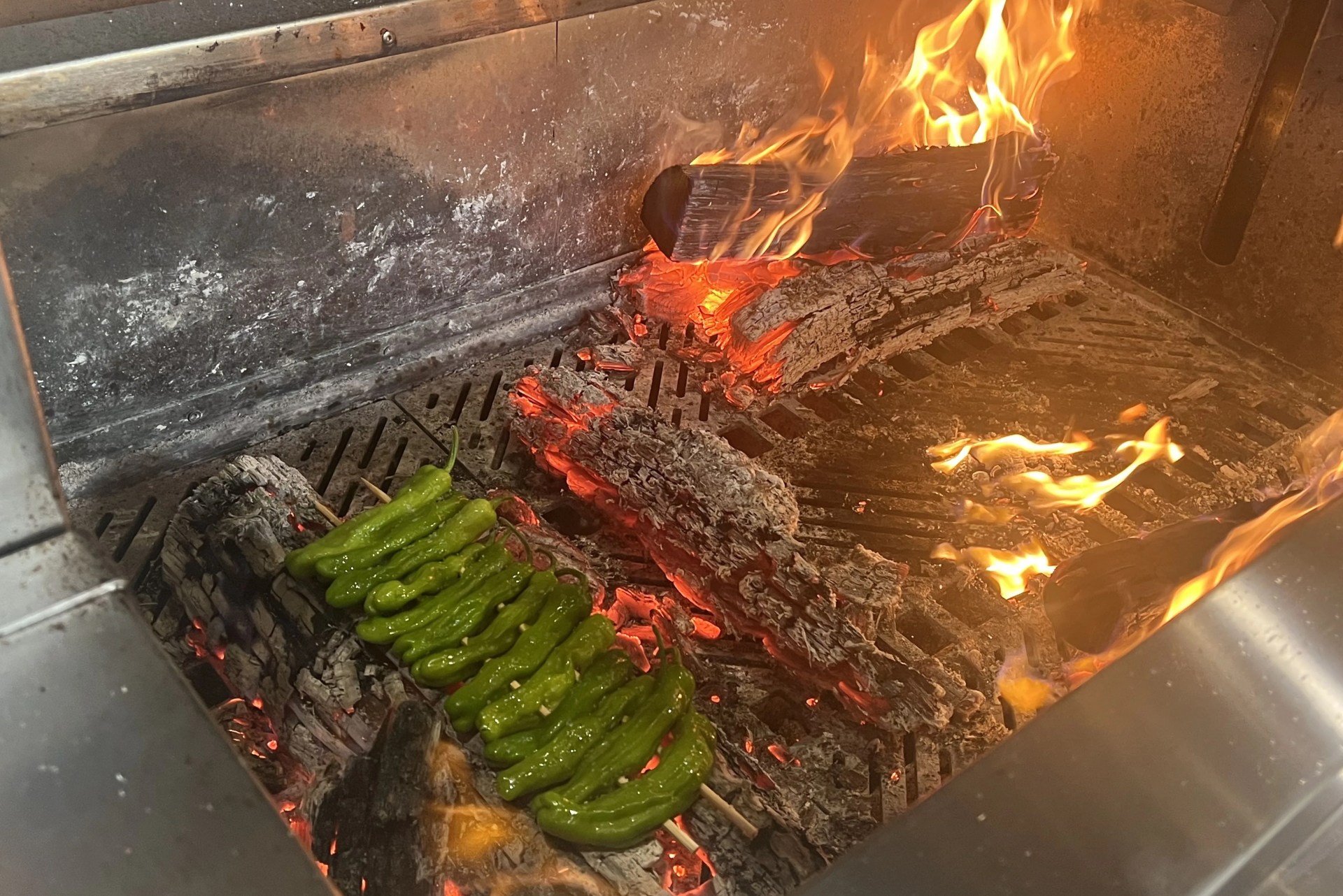 peppers cooking on coals