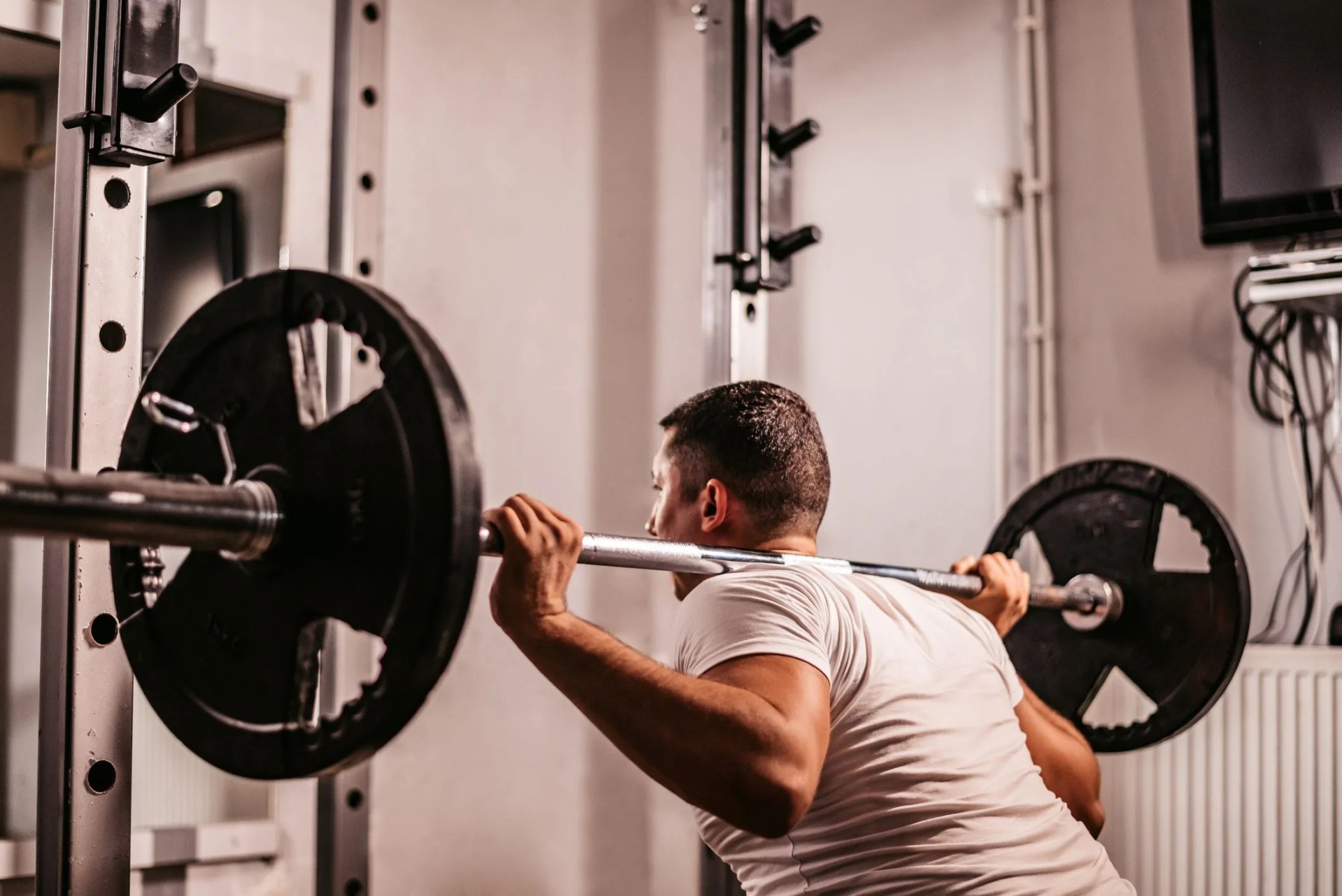 man doing barbell squats