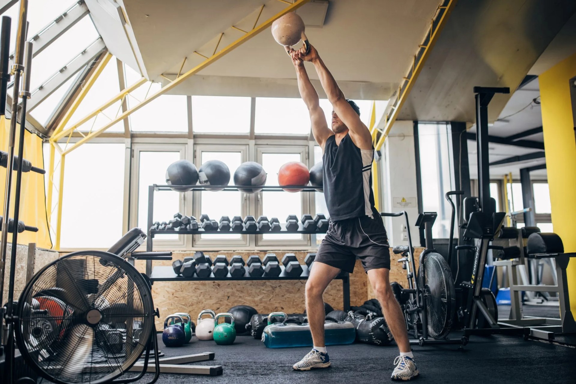 man training with kettlebell