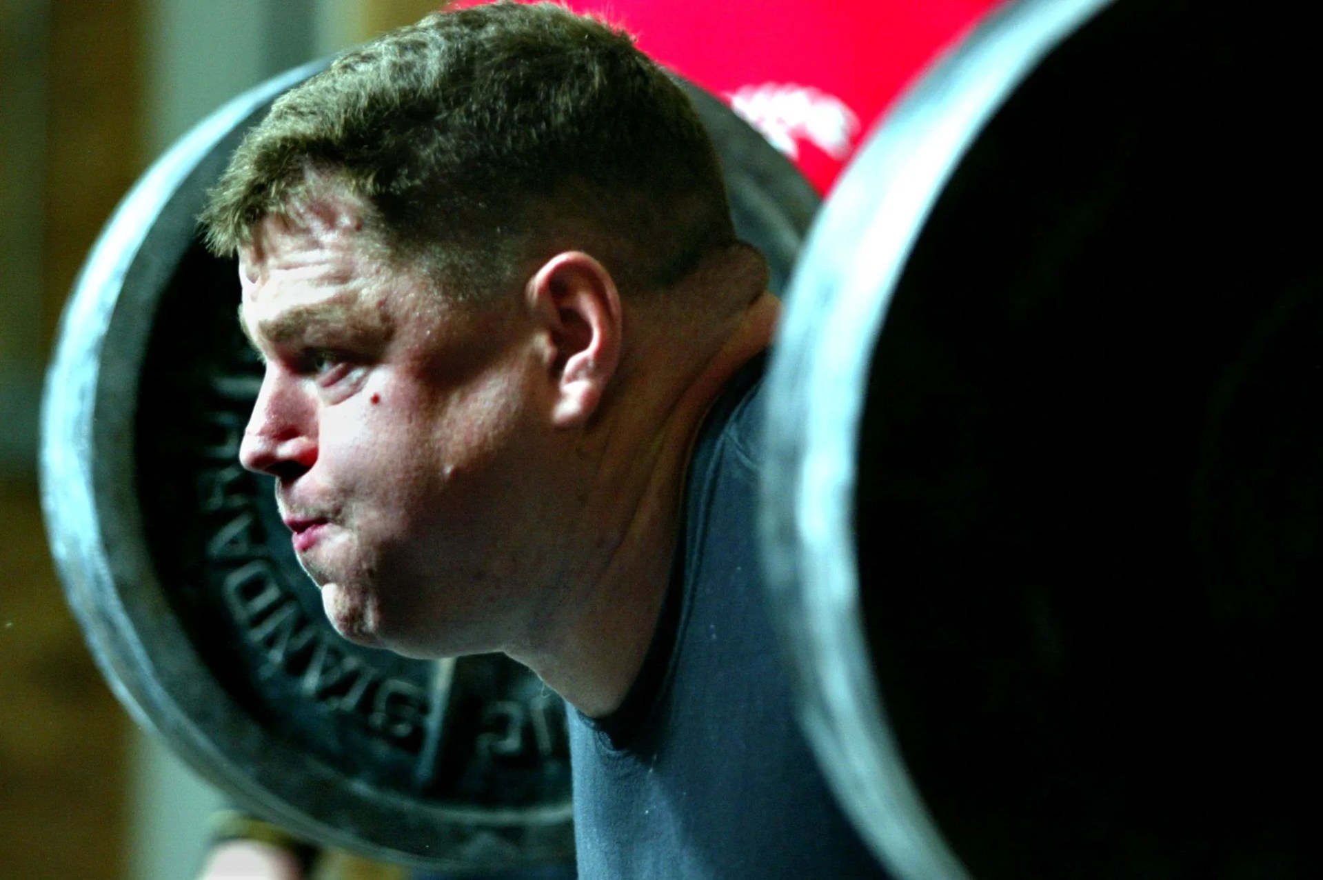 marshall 111002 brad gillingham, a world powerlifting champion, works out in a garage converted into a heavy weight gym with other power lifters in this photo gillingham puts effort into squat lifting over 400 pounds of weight in a workout set