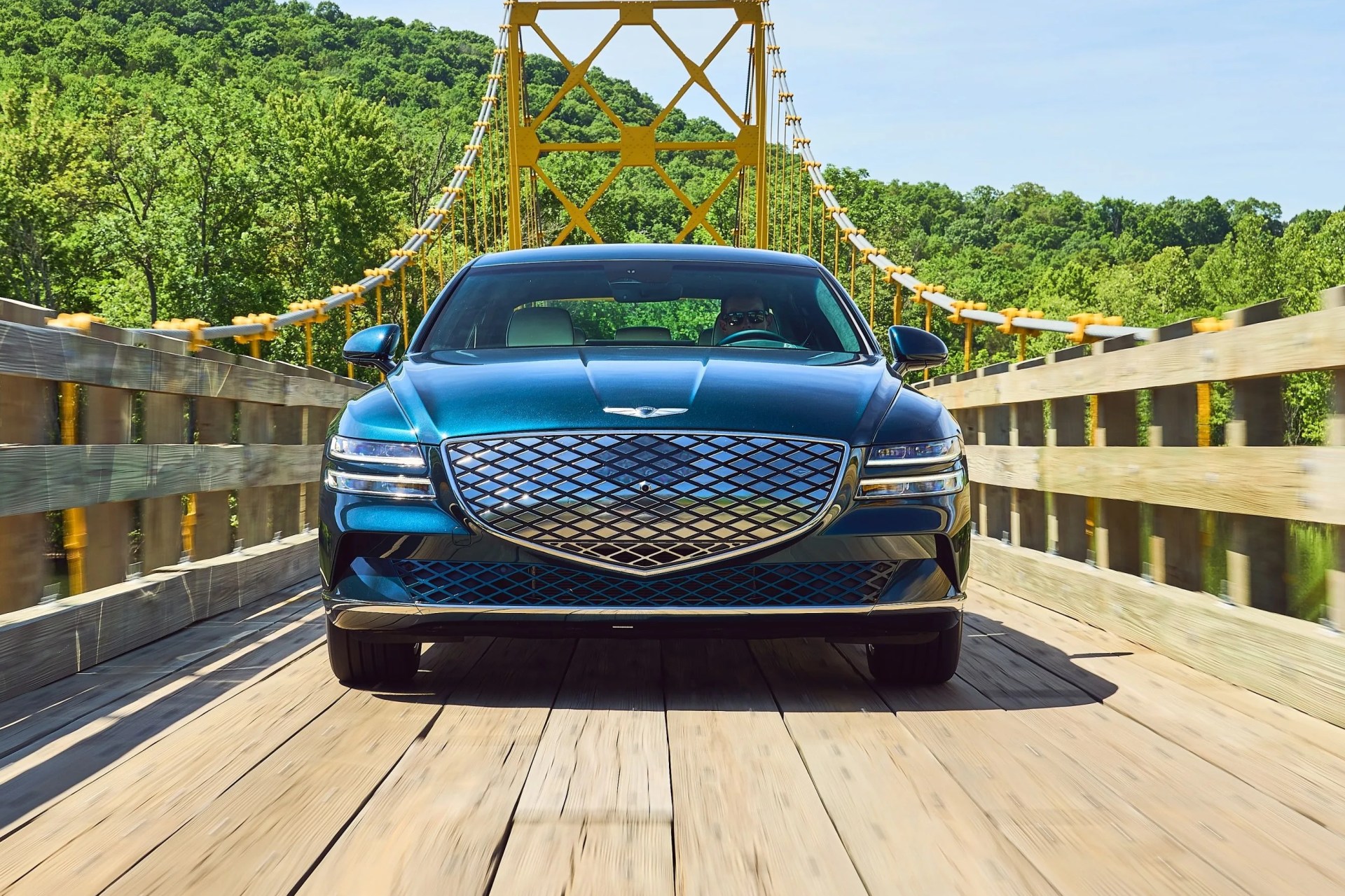 electrified g80 on a wooden suspension bridge