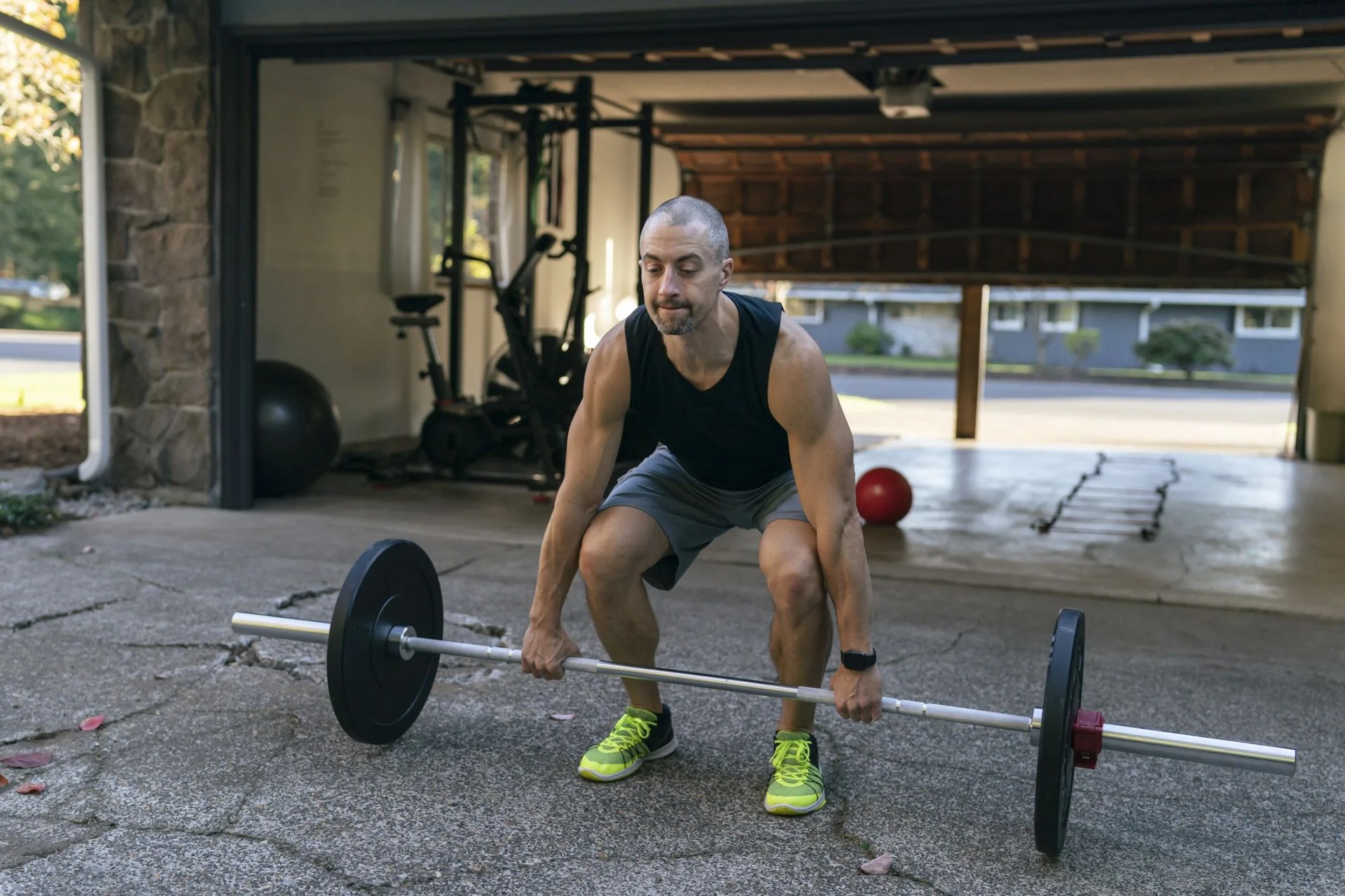 muscular man exercising at home in driveway