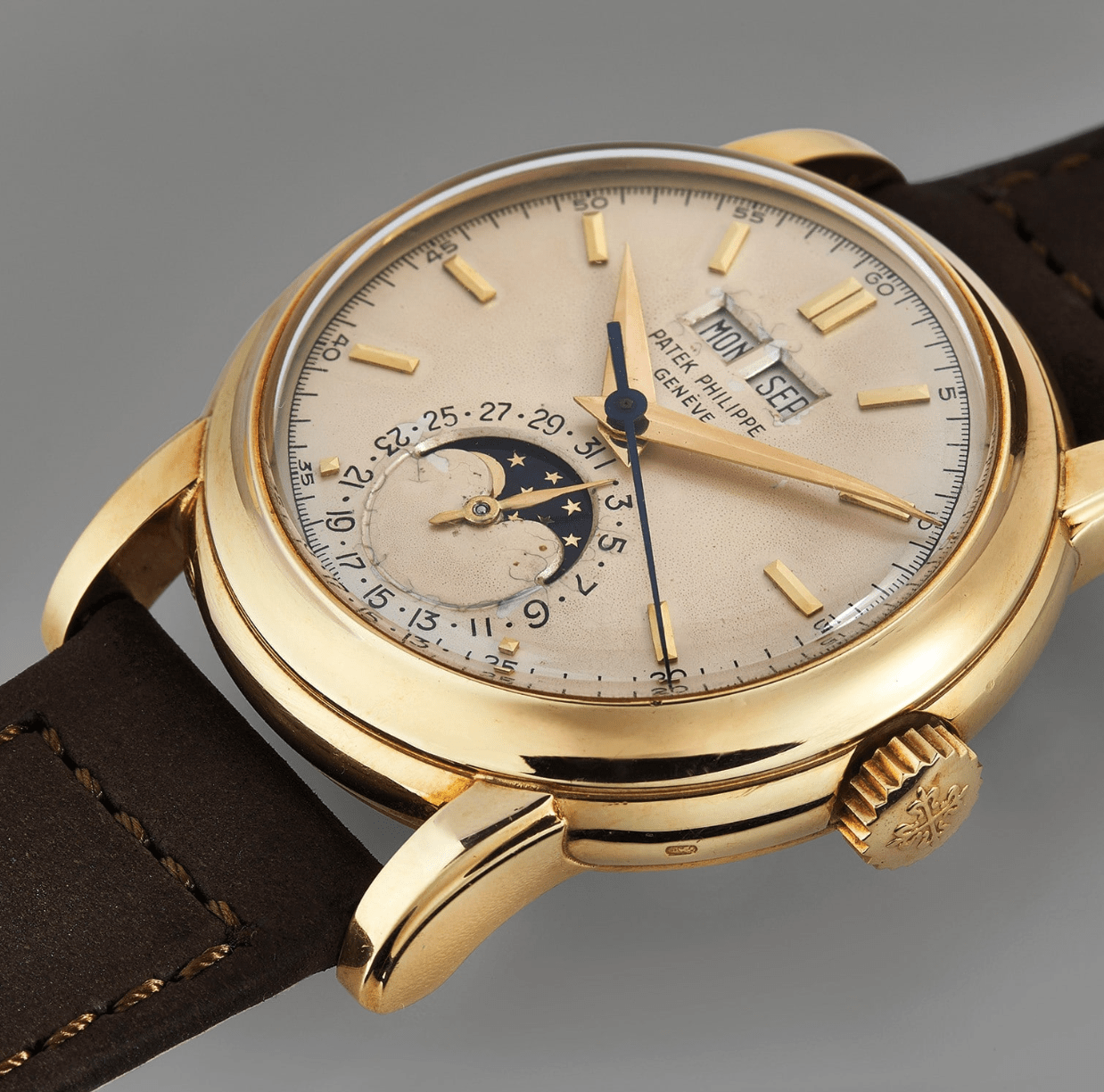 gold watch laying flat on a table