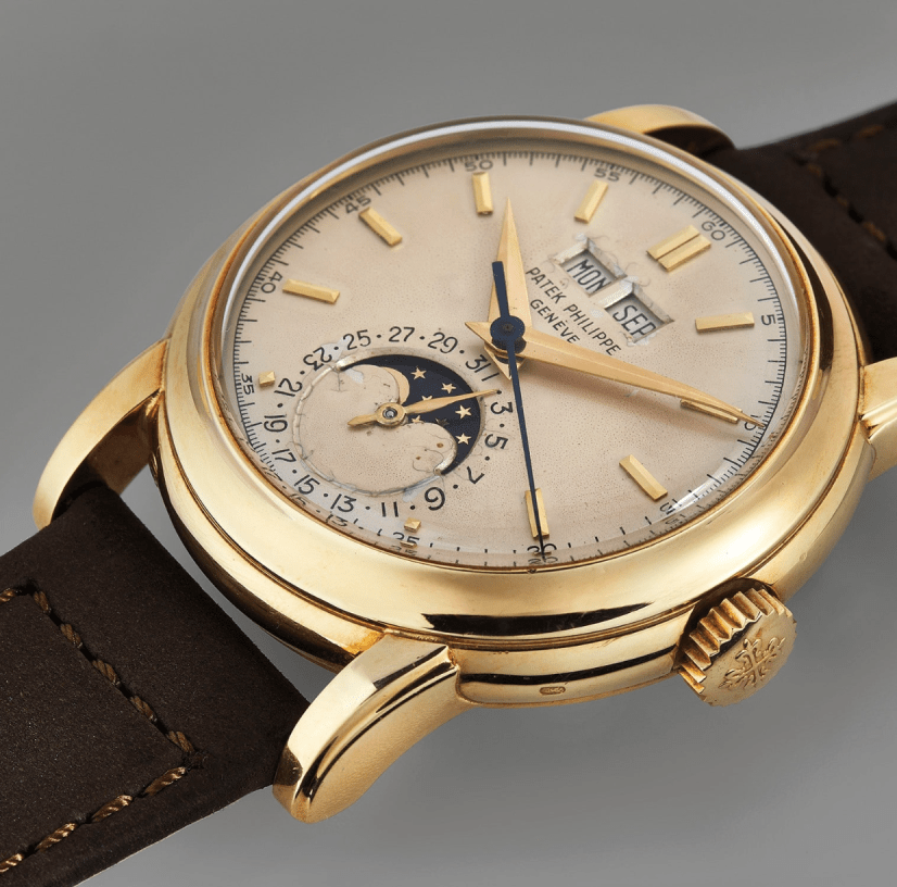 gold watch laying flat on a table