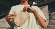person opening belt bag