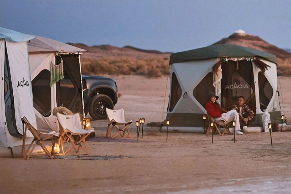 people camping in a space acacia tent