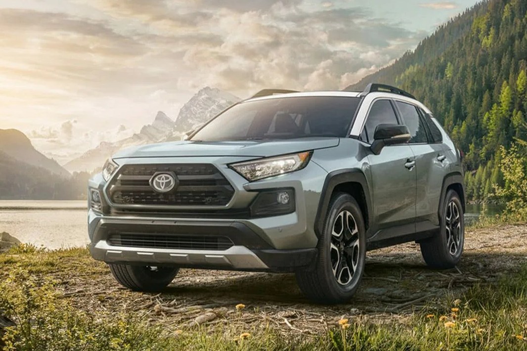 toyota rav4 parked by a river in the mountains