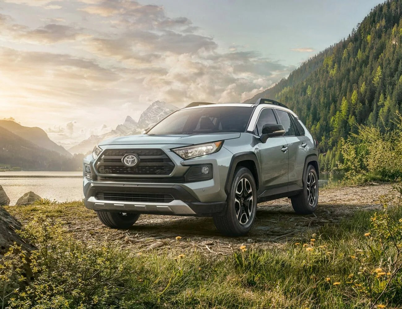 toyota rav4 parked by a river in the mountains