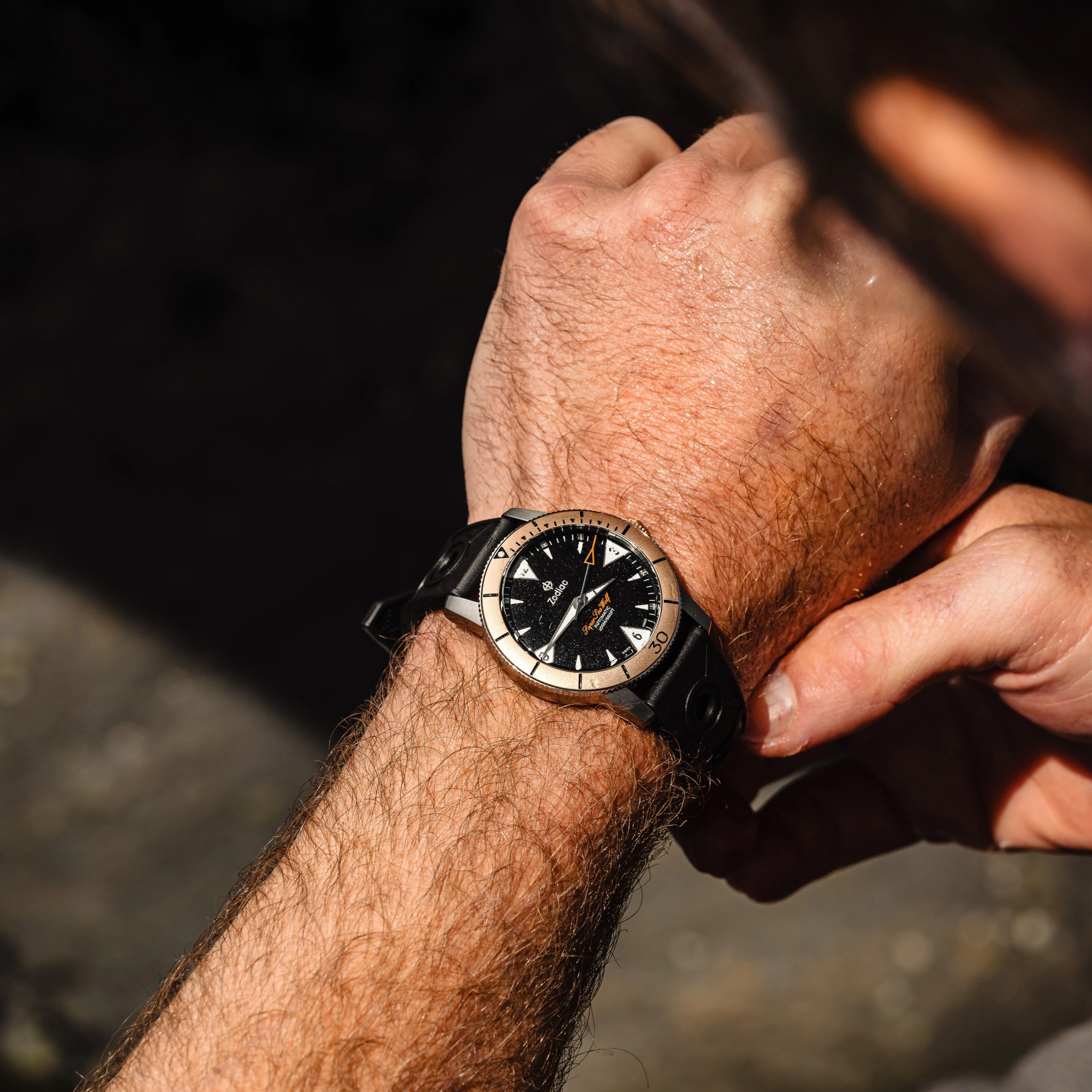 watch with bronze bezel on a wrist