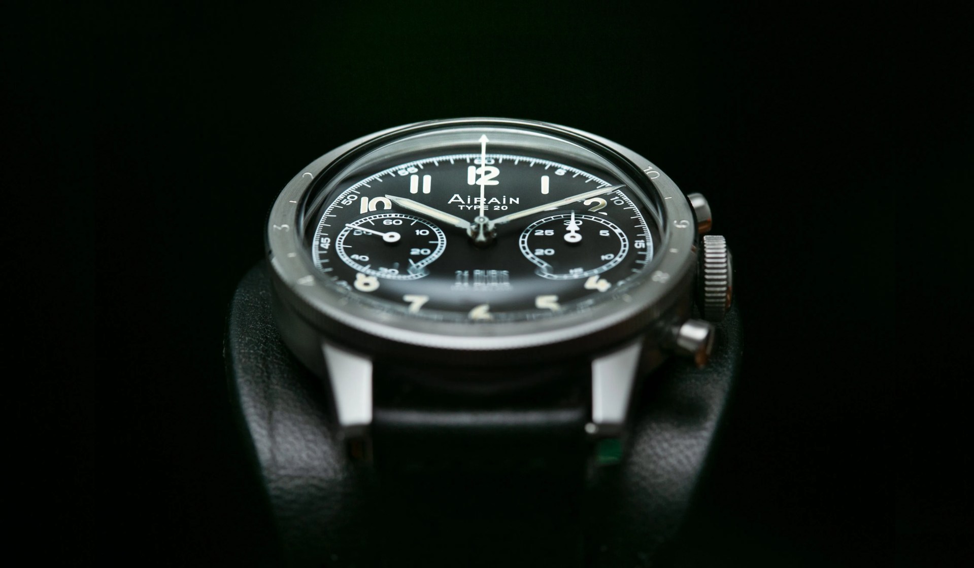 black chronograph watch on a bund leather strap