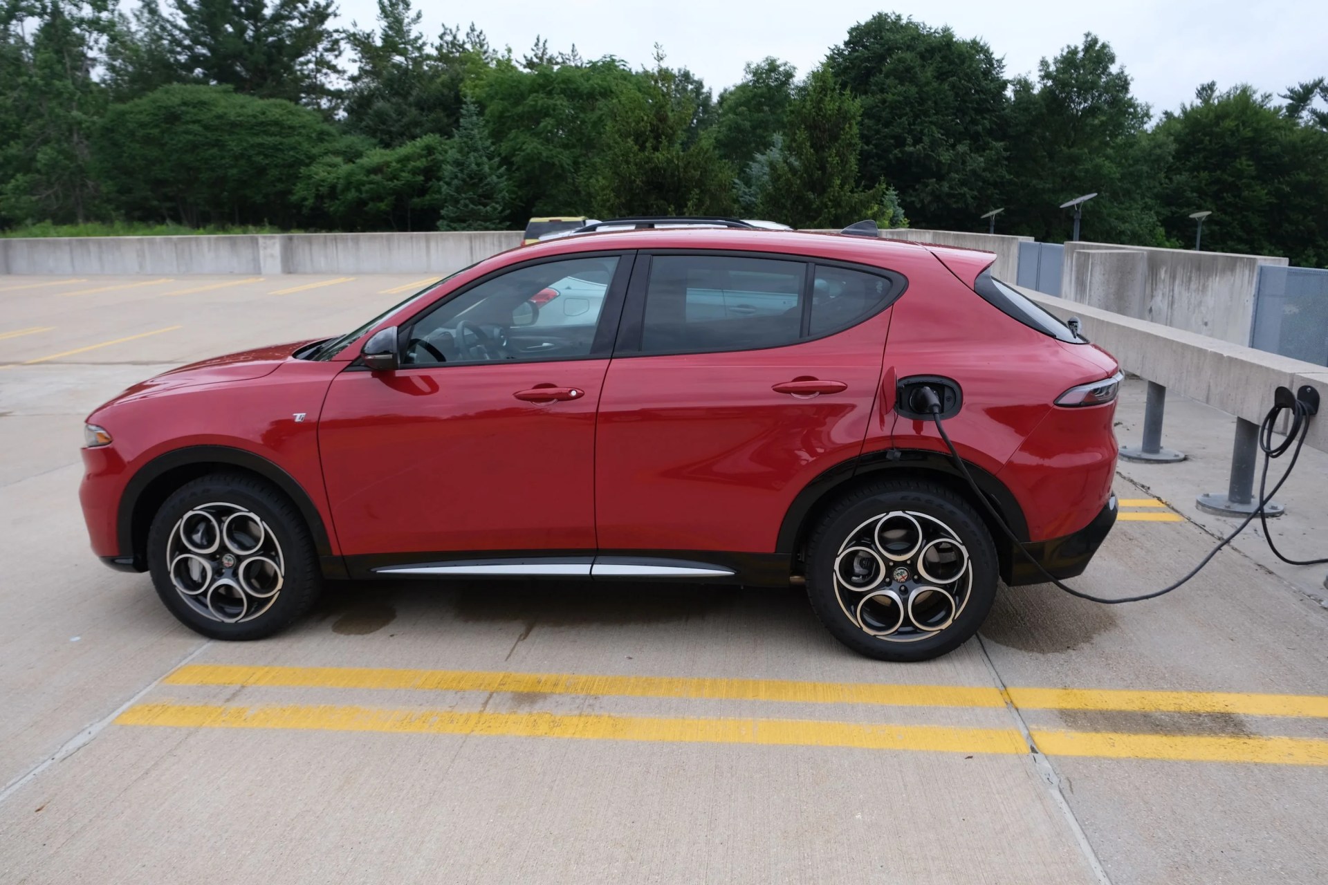 alfa romeo tonale crossover charging in parking lot