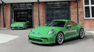green porsche parked outside of a garage