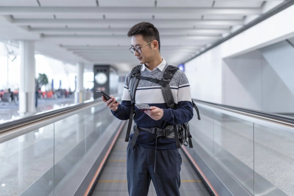 asian man waiting for the plane at the airport