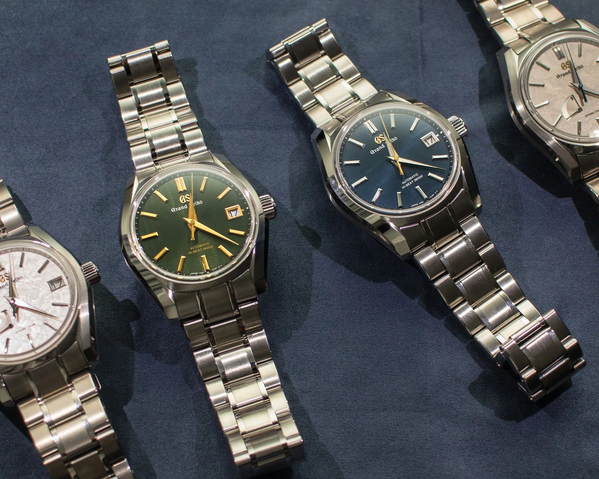 four grand seiko watches on a blue cloth