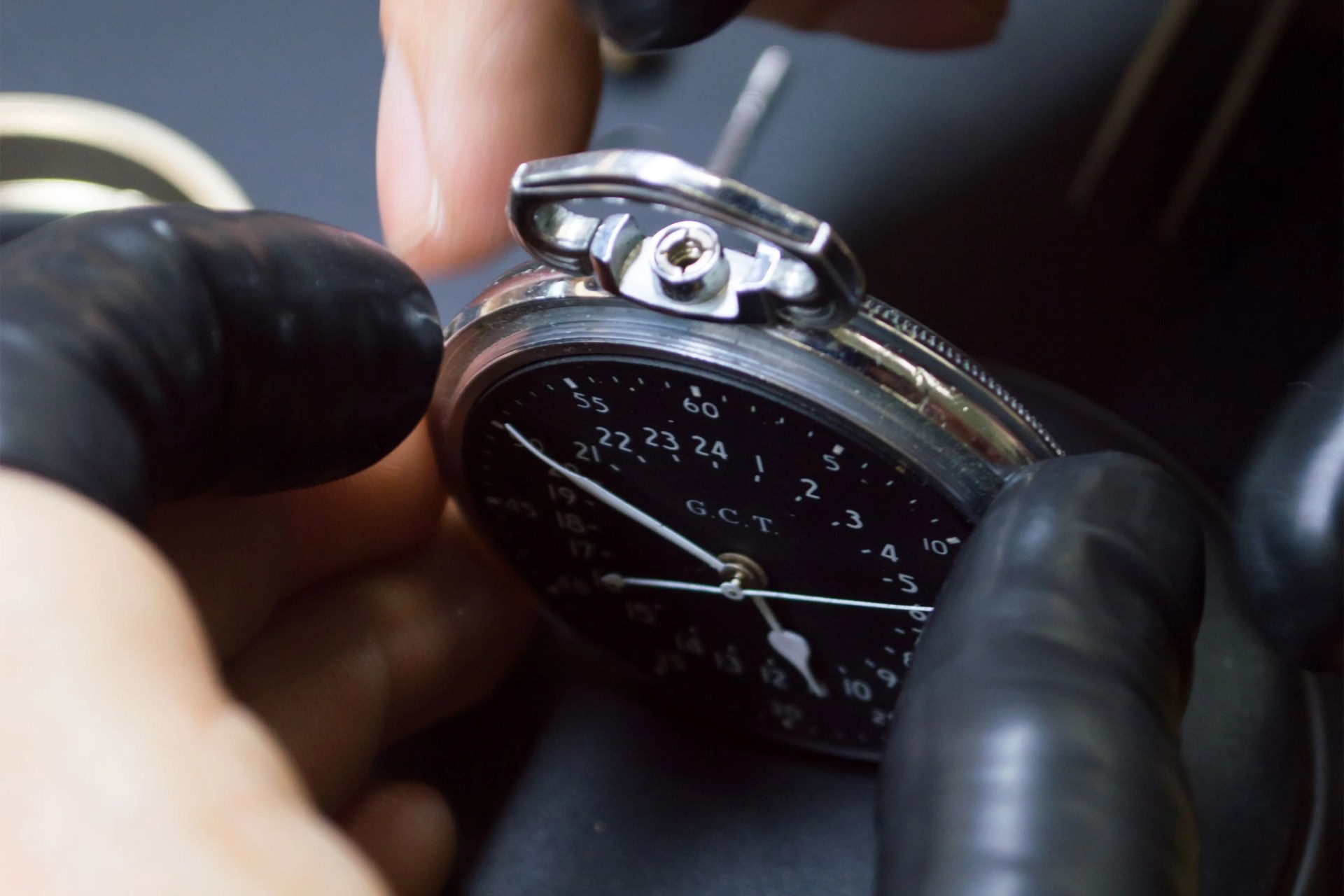 a person putting a watch face together