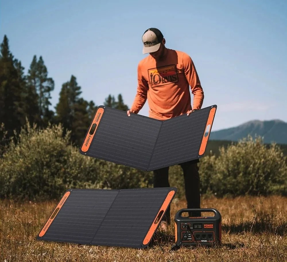 man folding up jackery solar panels
