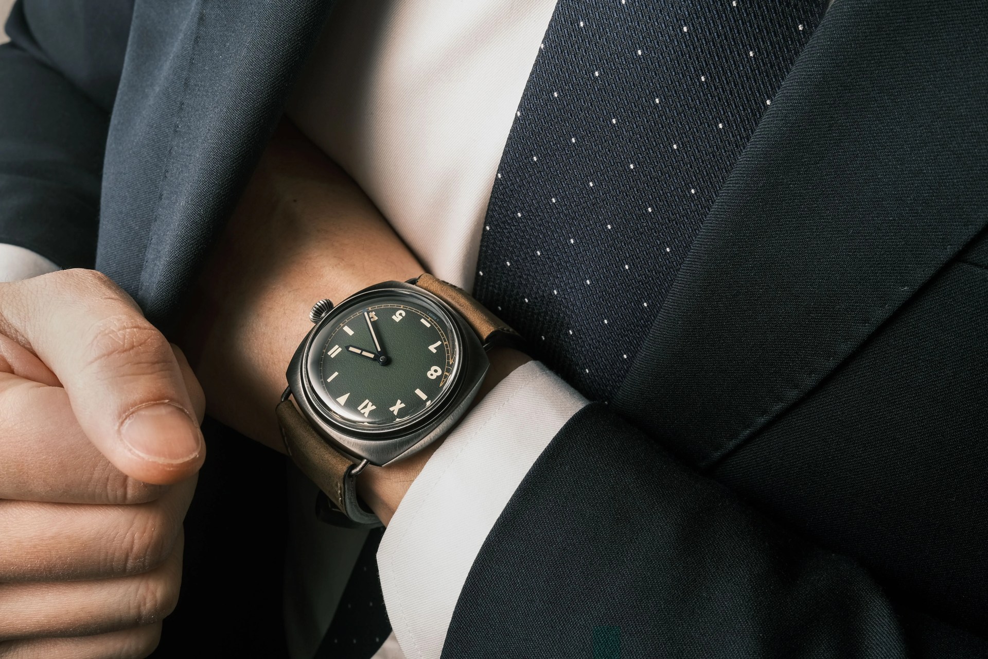 panerai watch on wrist with suit and tie