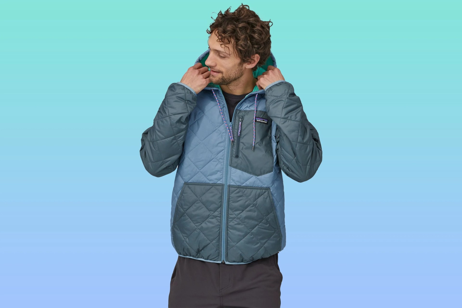 a man wearing a patagonia zip up quilted jacket