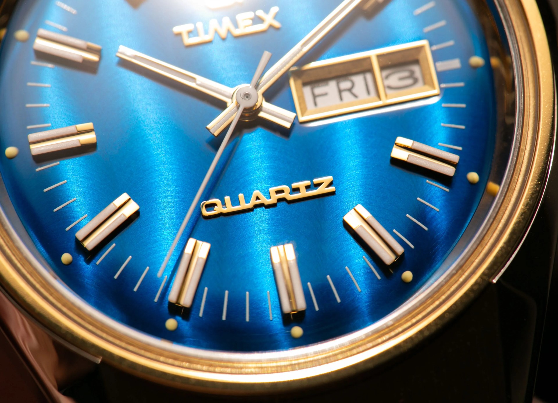 closeup of watch dial with focus on the word quartz