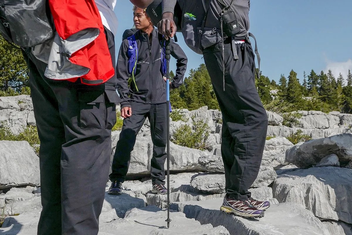 a group of people standing on rocks in hiking gear