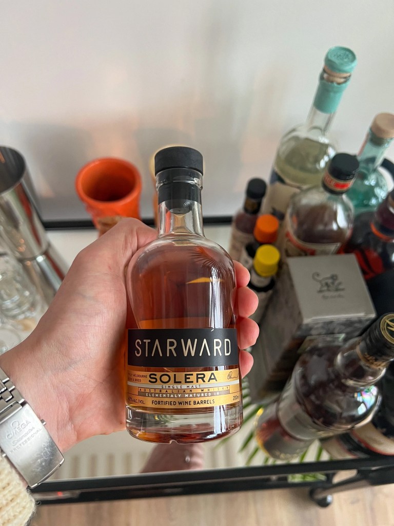bottle of whisky in a hand