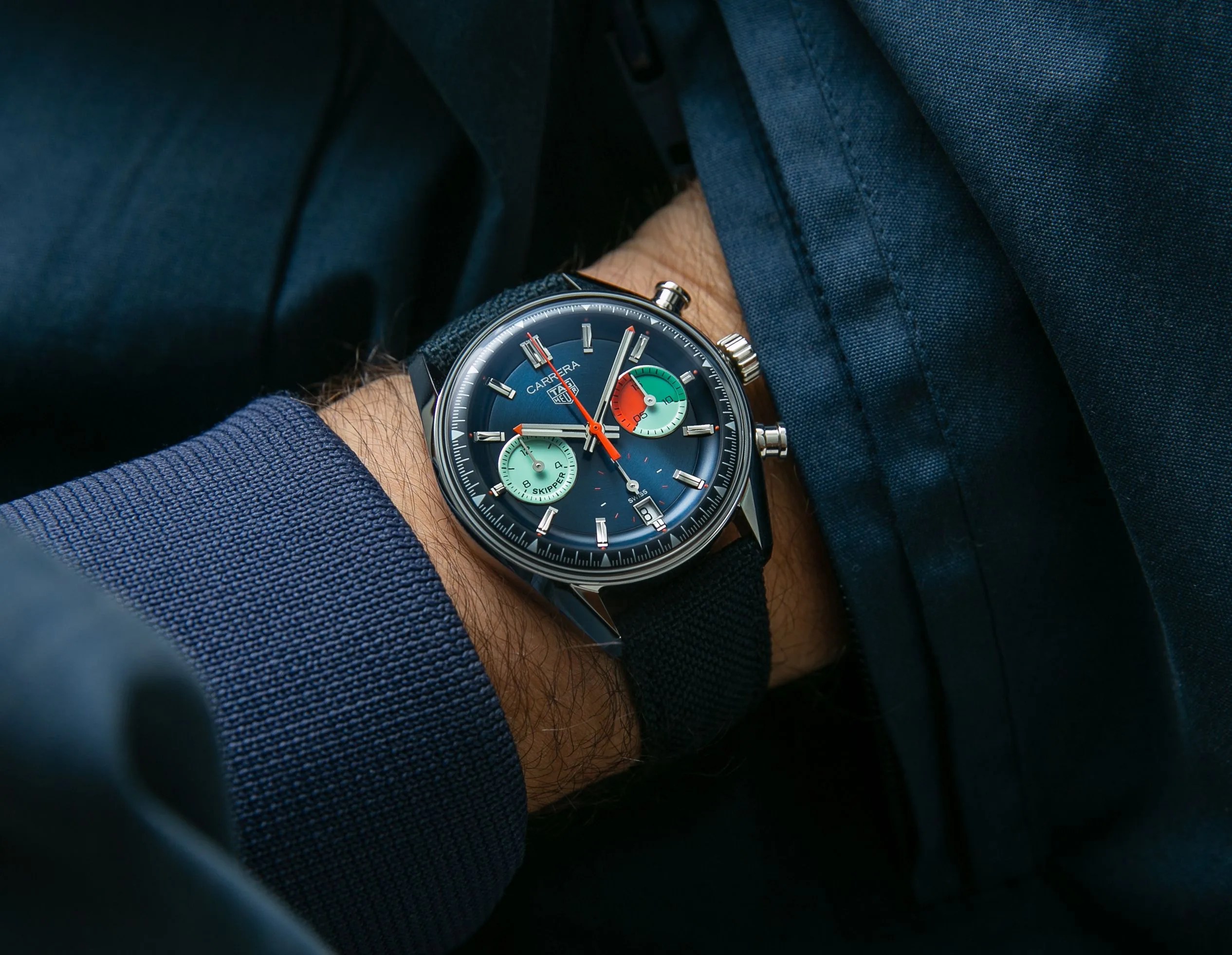 colorful chronograph on wrist with blue jacket