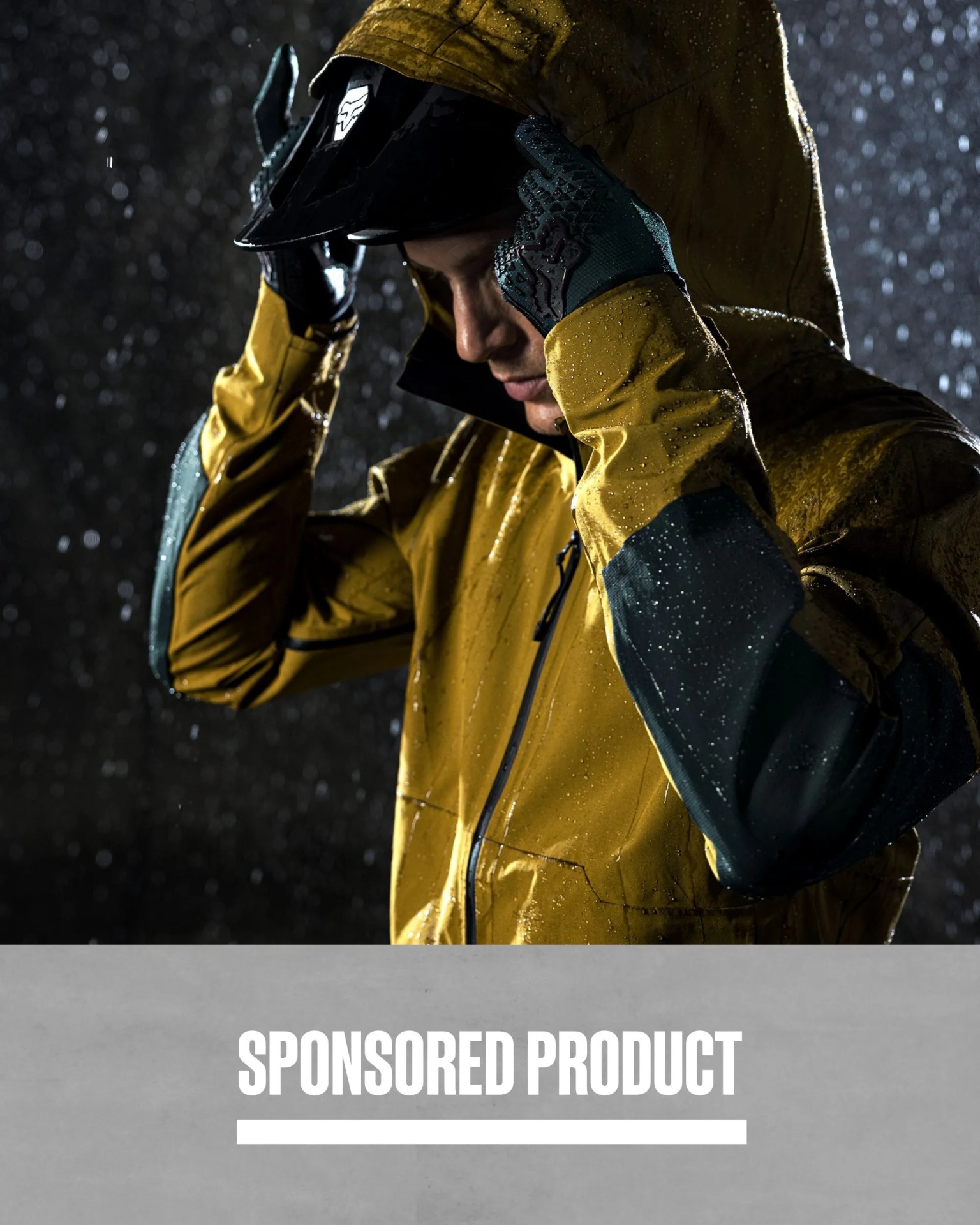 sponsored product man wearing fox racing’s defend 3 layer water jacket in the rain