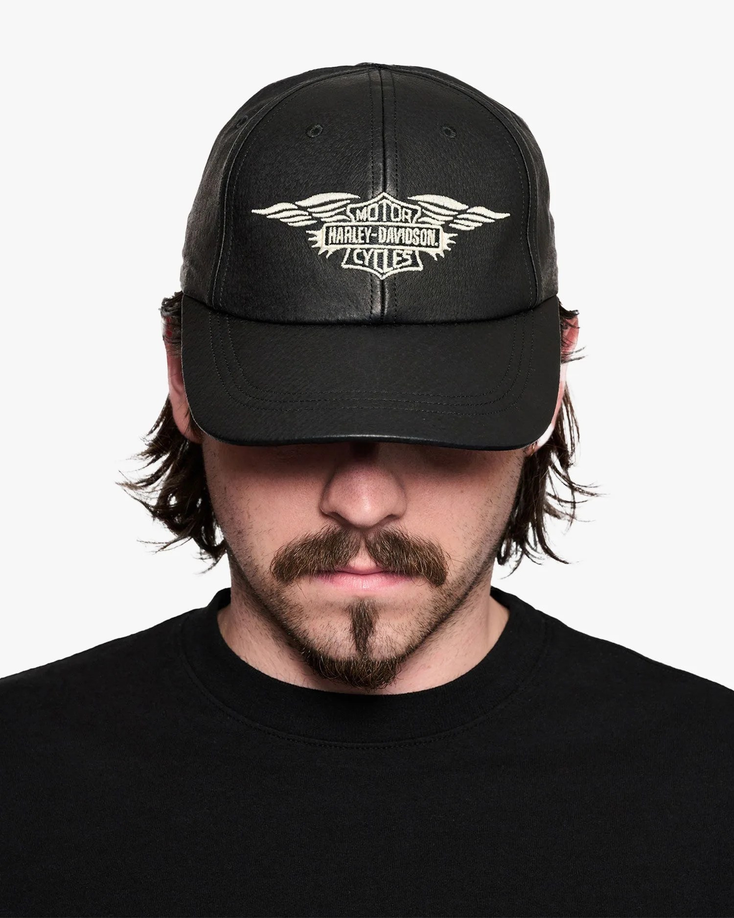 man wearing harley davidson silver wing leather cap