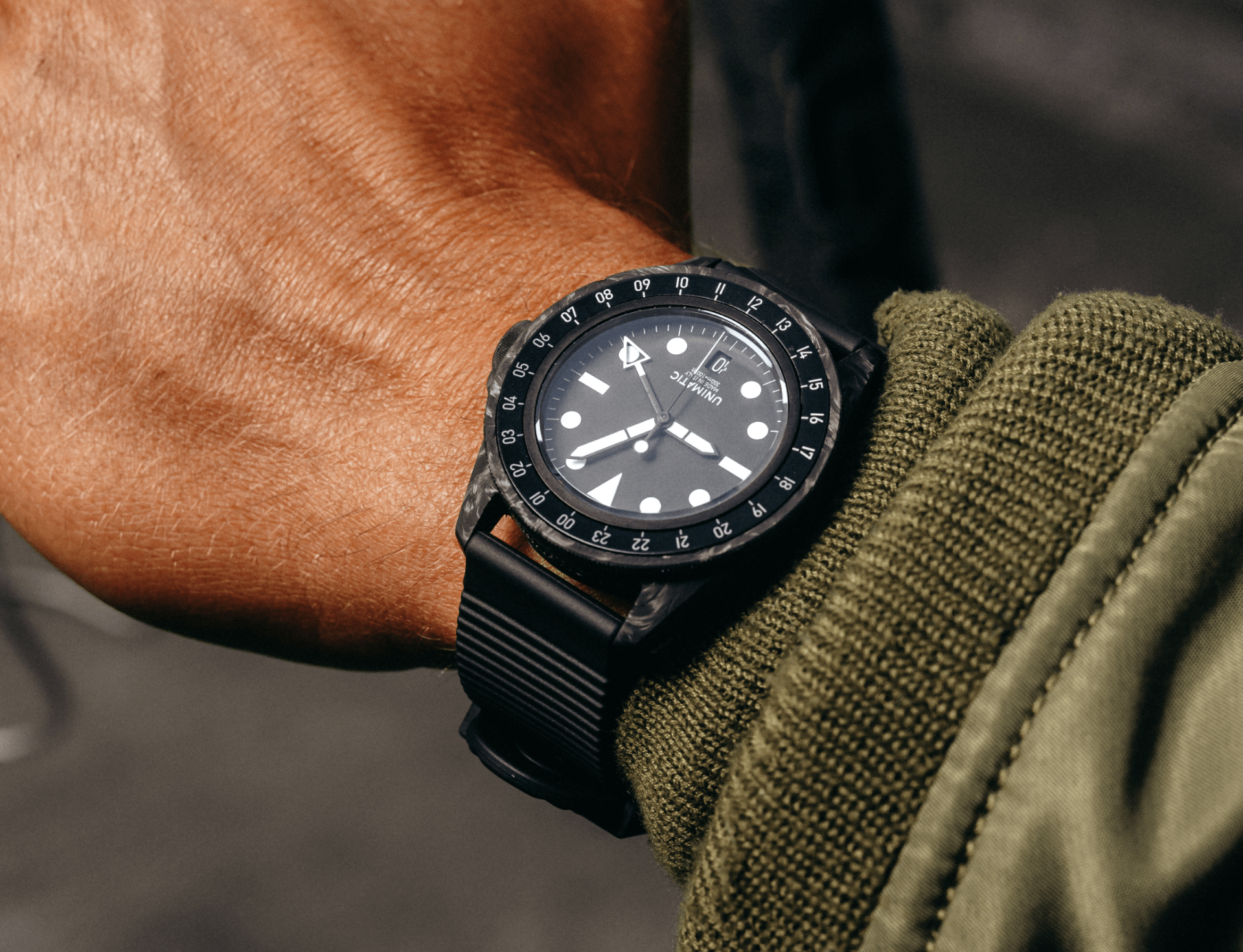 carbon watch worn on a wrist of a cyclist