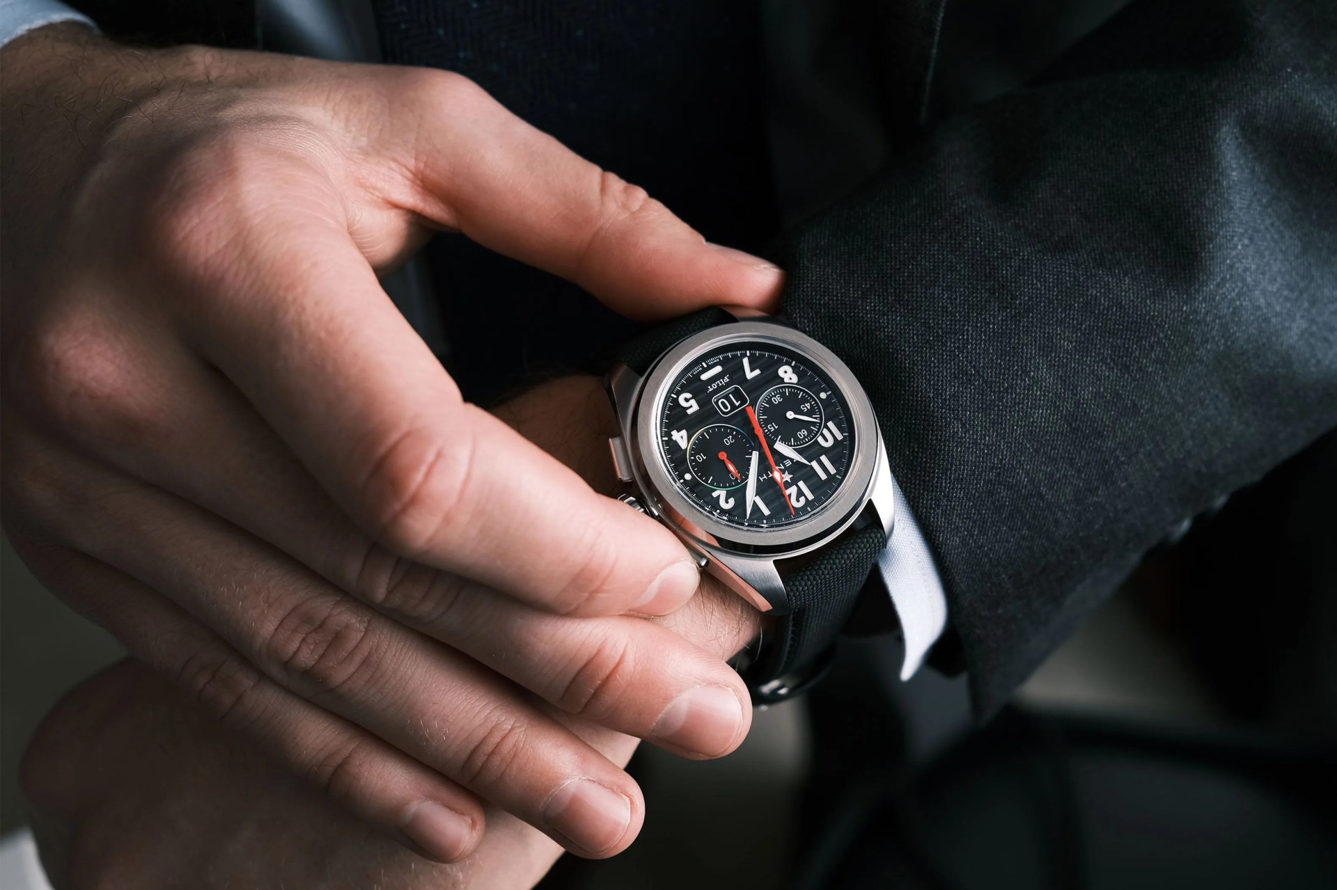 chronograph watch on wrist with red seconds hand
