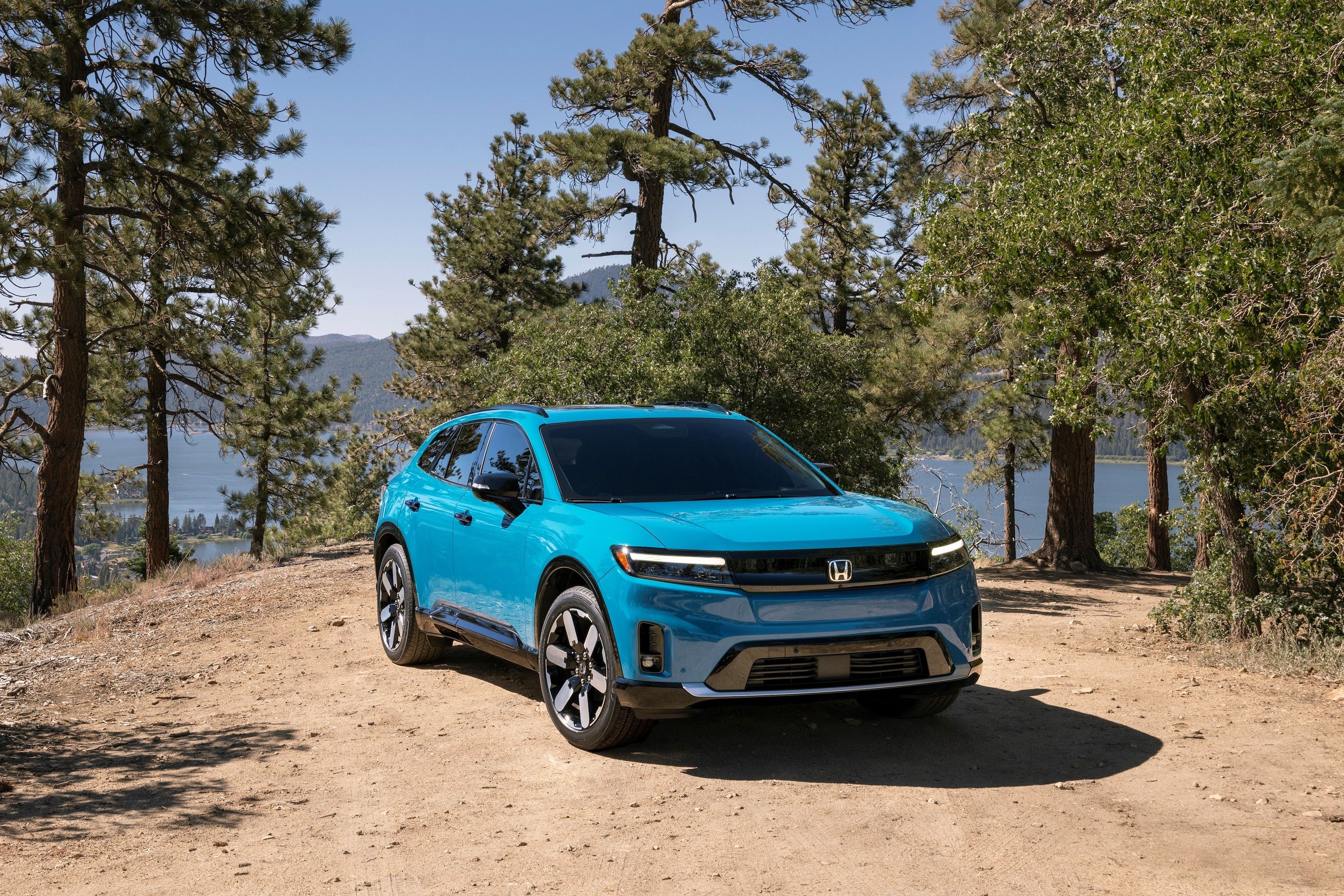 honda prologue parked with a lake and trees in background