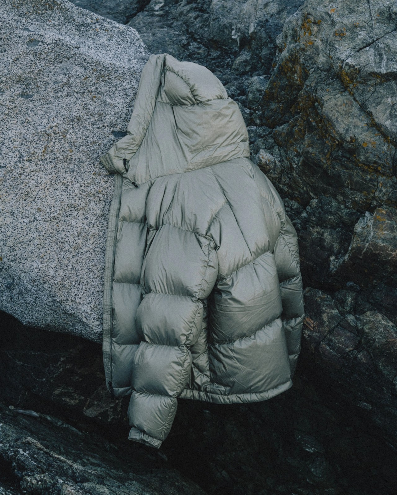 a goldwin parka hanging on a rock