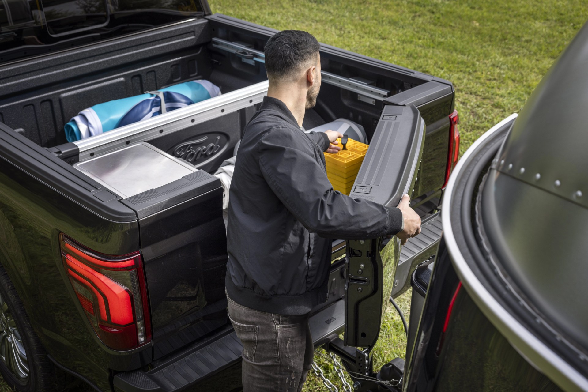 man pulling gear out of ford f150 bed