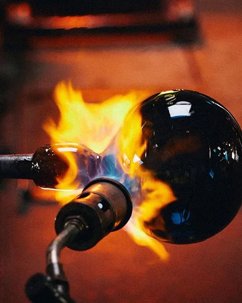 fire torch heating up a ball of glass