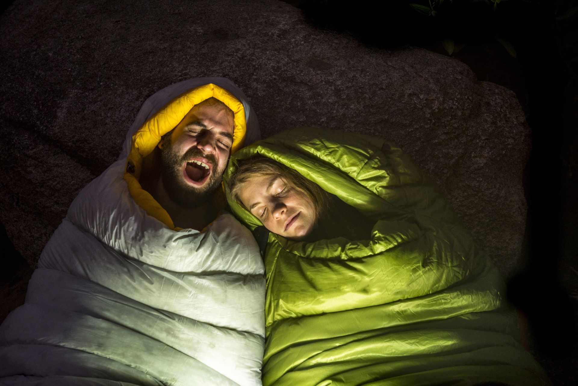 man and woman sleeping in sleeping bags