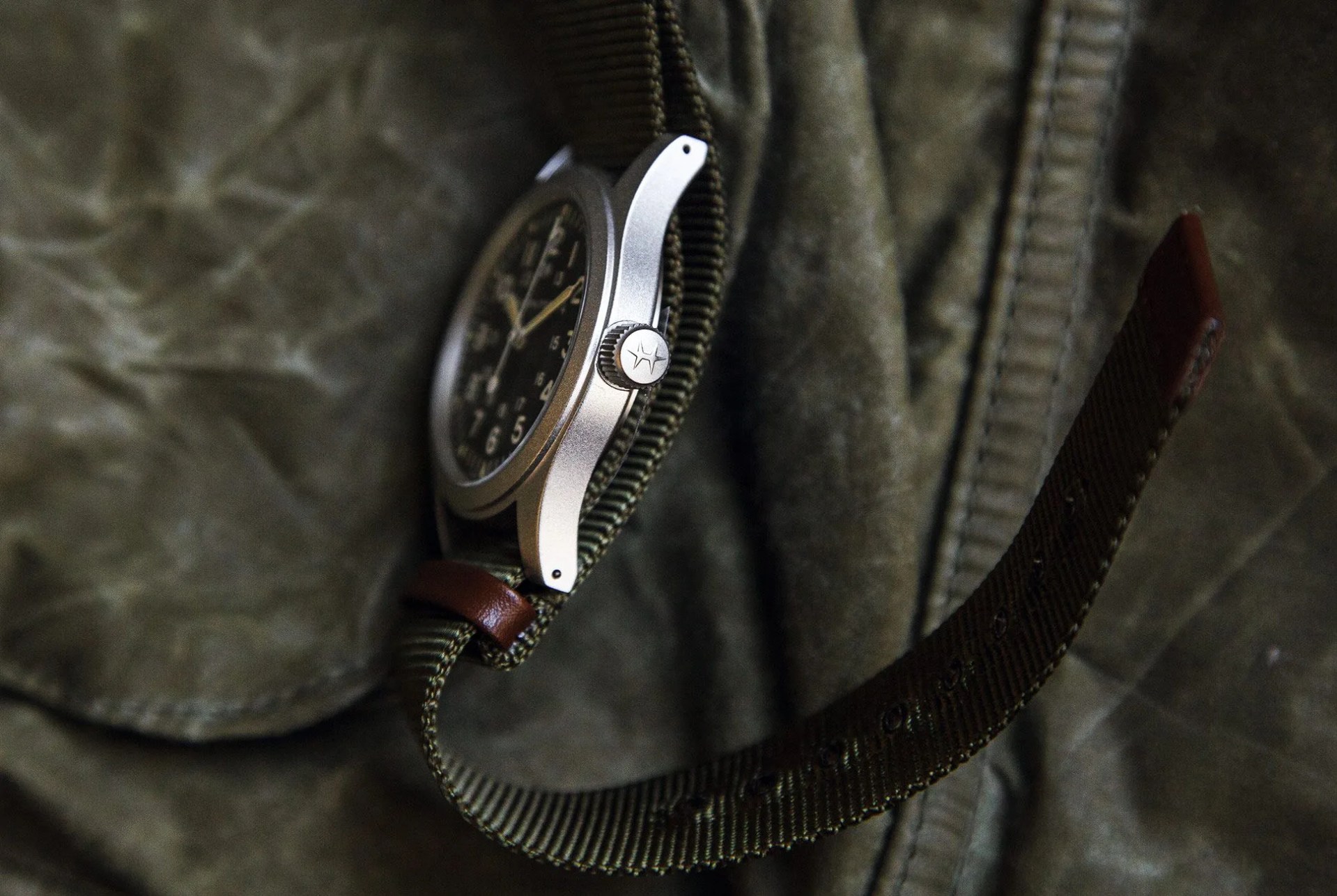 the hamilton khaki field mechanical watch laying on its side