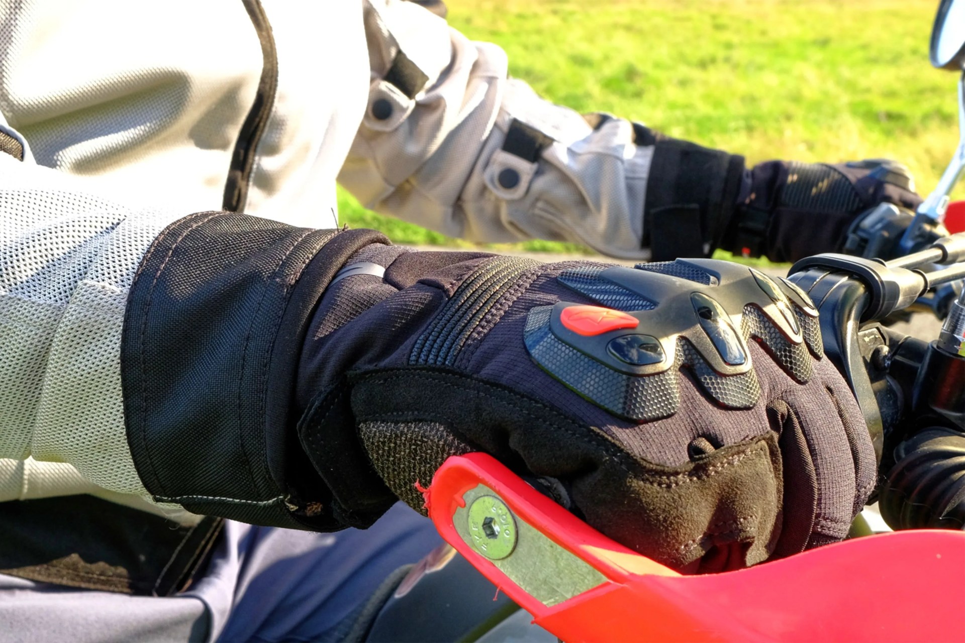 hands wearing gloves on a motorcycle