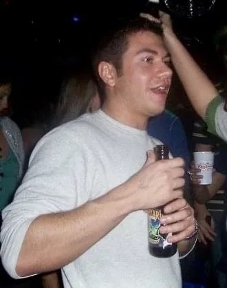 man holding beer at a party