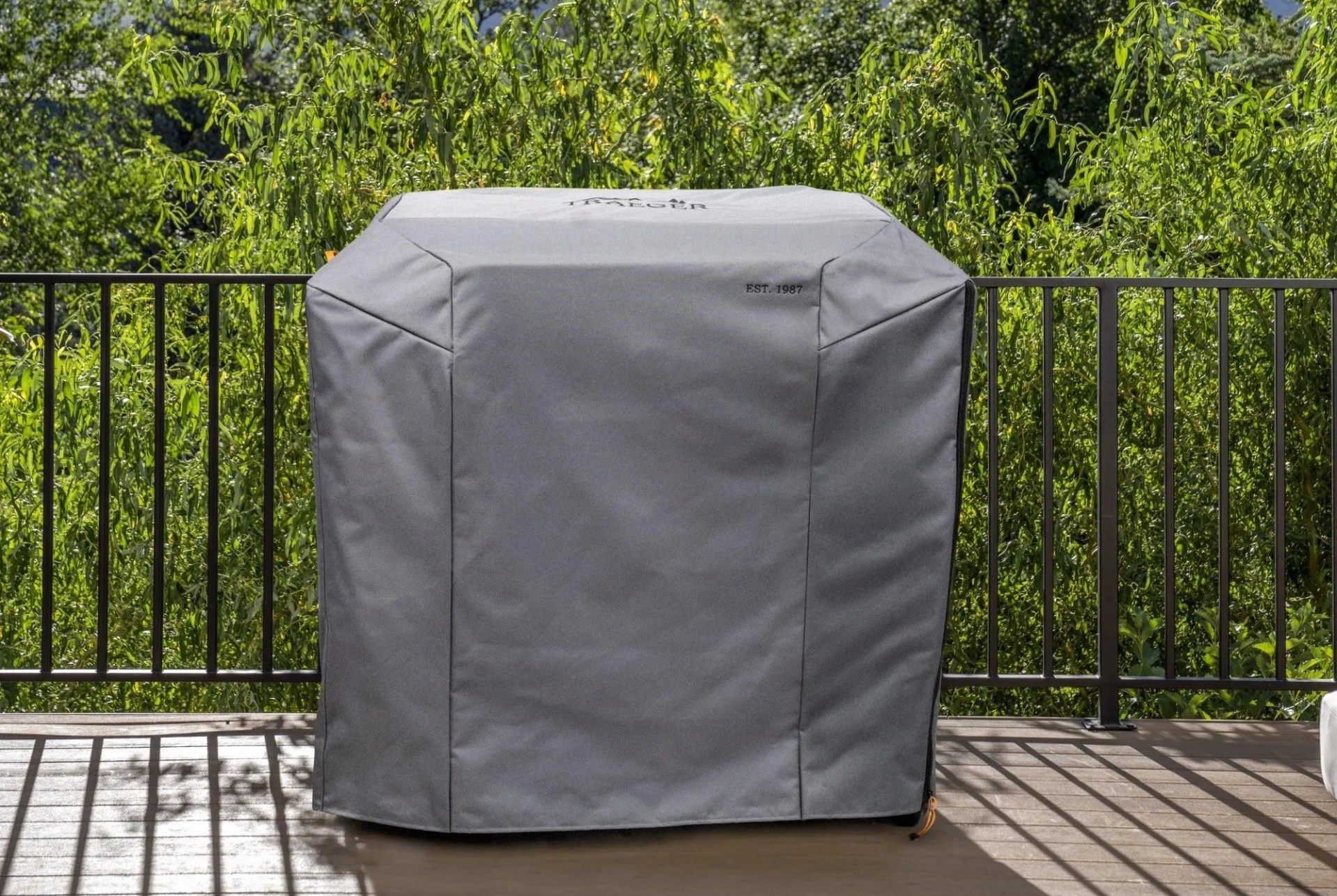 a grill on a deck with a cover