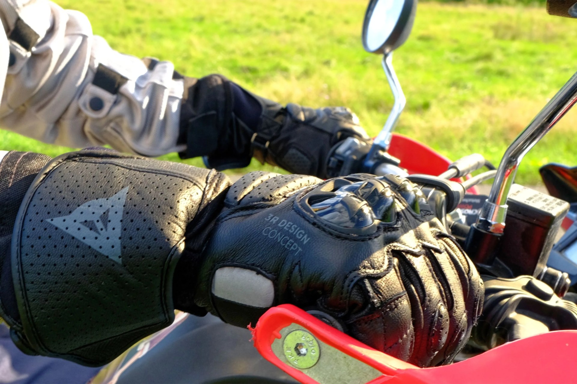 close up of hands with gloves on a motorcycle
