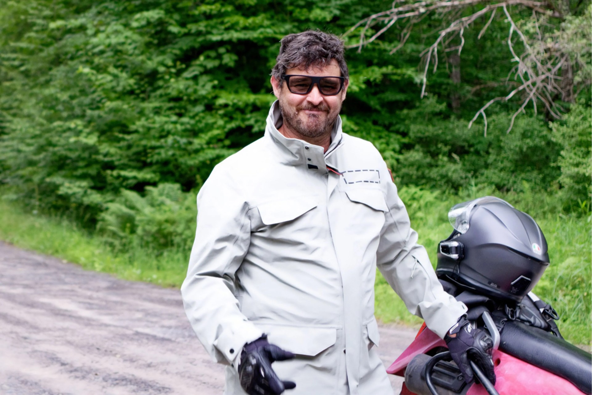 a man standing next to a motorcycle