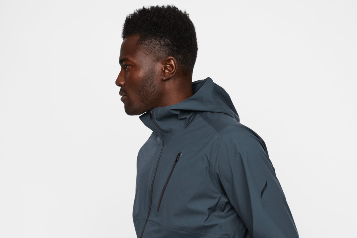 a model wearing a gray rain jacket