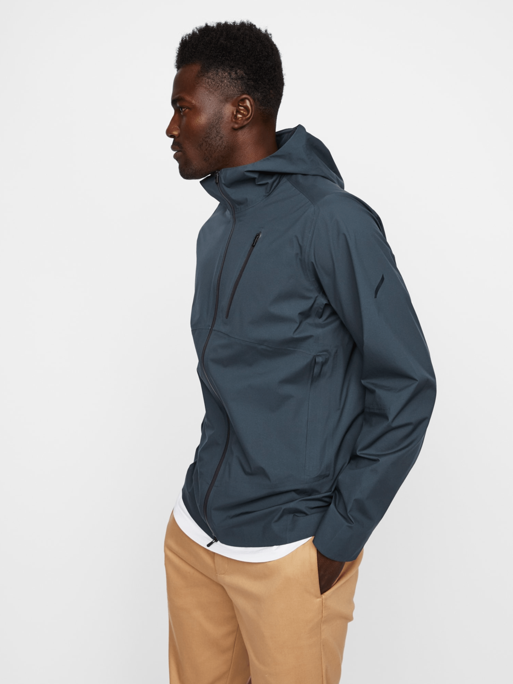 a model wearing a gray rain jacket