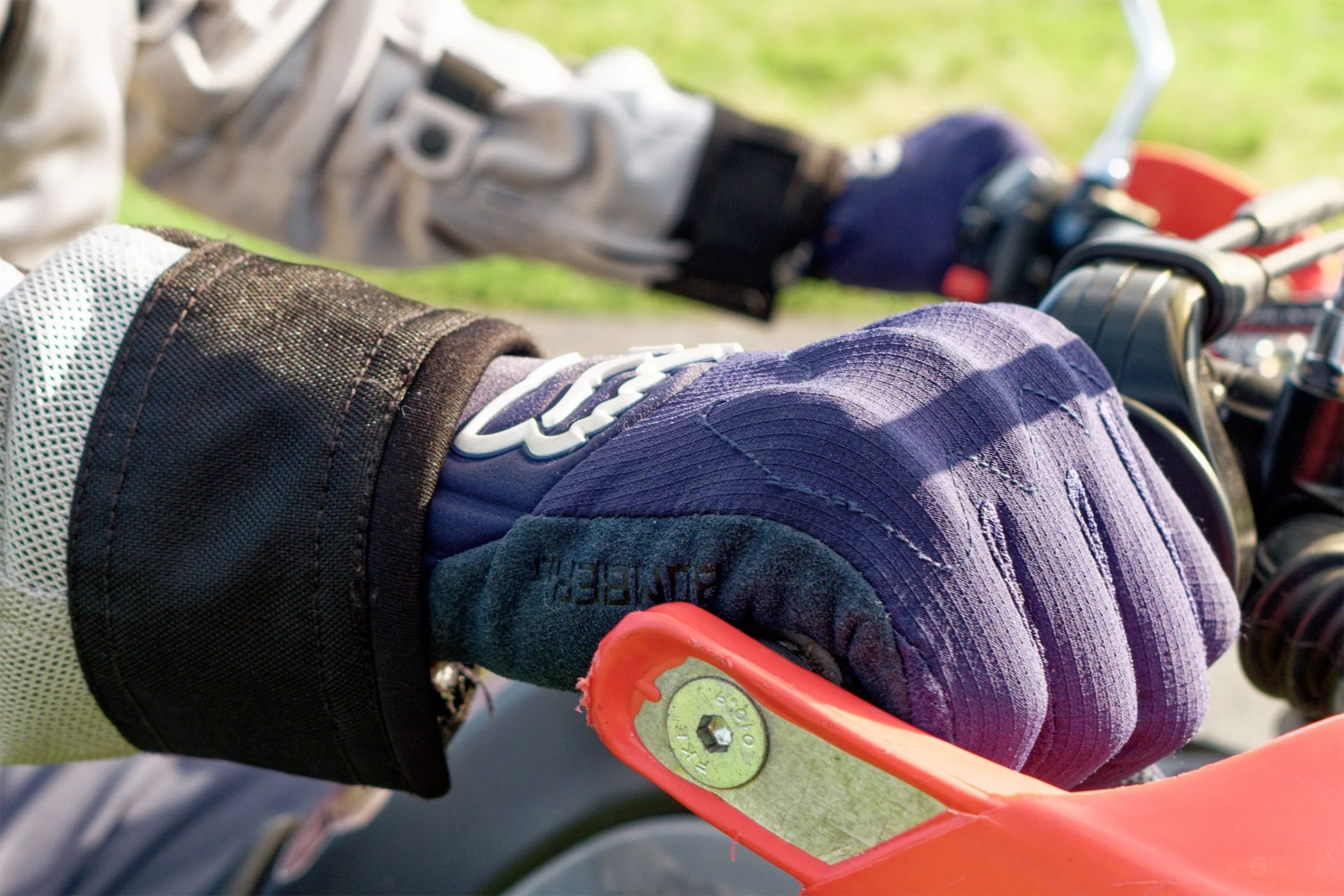 close up of a hand with a glove on a motorcycle