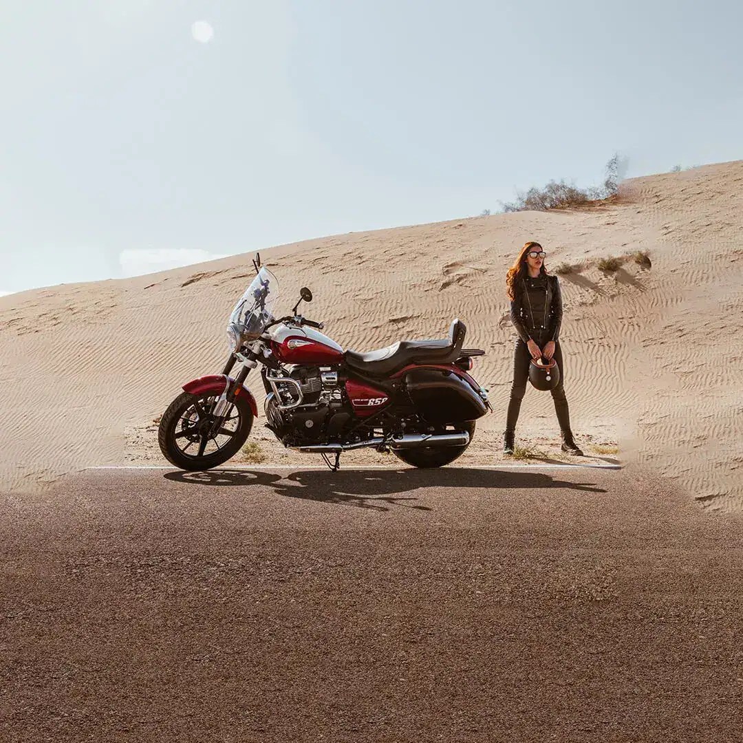 motorcyclist in desert with motorcycle and helmet