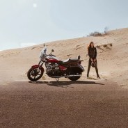 motorcyclist in desert with motorcycle and helmet