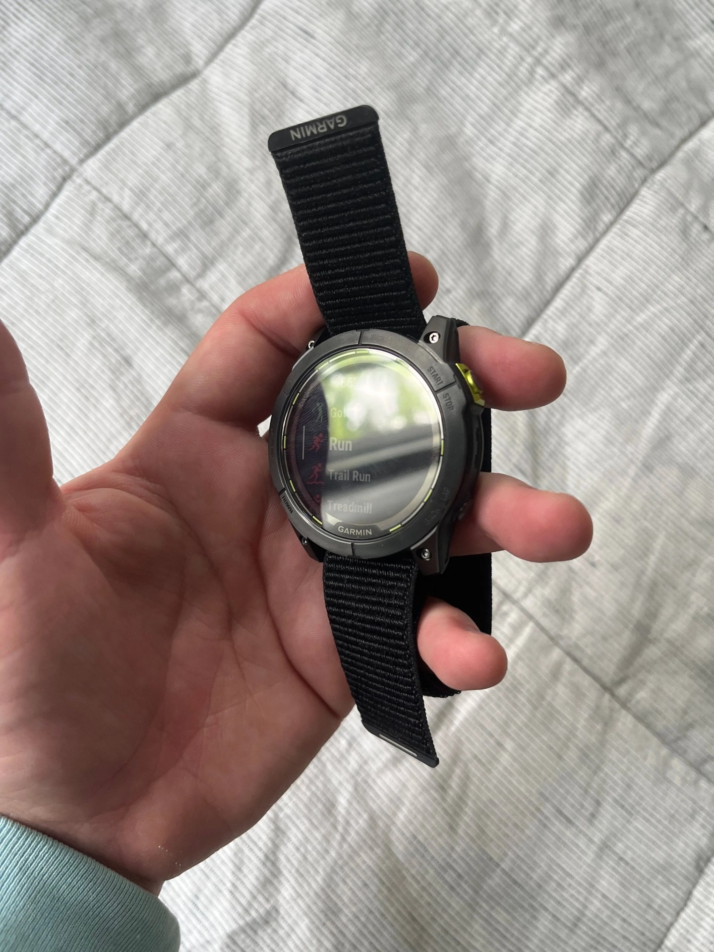 a garmin watch in a hand