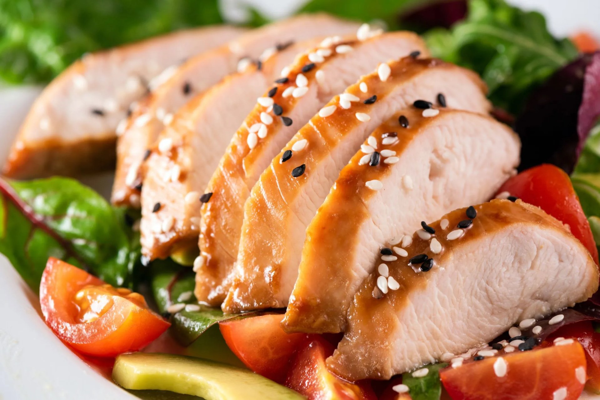 roasted turkey or pork slices served with green salad leaf and tomatoes closeup view