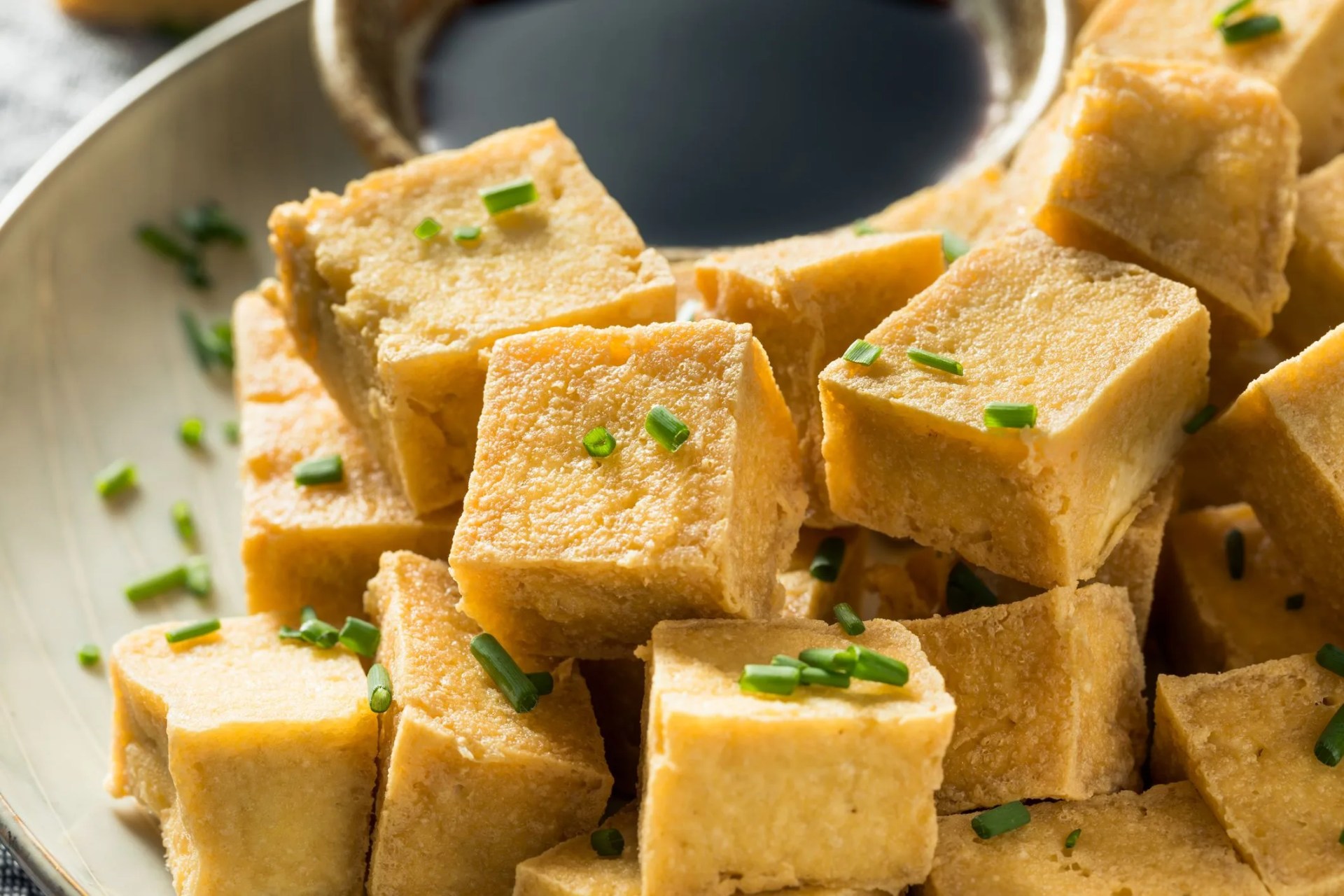 homemade asian fried tofu cubes with soy sauce
